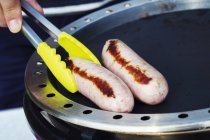 Sausage being fried on stove — Stock Photo
