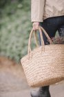 Woman with basket with flowers. — Stock Photo