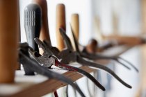 Rack of hand tools along window — Stock Photo
