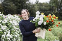 Femme travaillant dans la pépinière de fleurs biologiques — Photo de stock