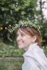 Woman with a flower wreath — Stock Photo