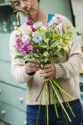 Female florist creating bouquet — Stock Photo