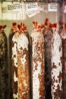 Chorizo sausages hanging from hooks — Stock Photo