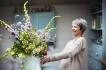 Floristin arbeitet mit Blumen — Stockfoto