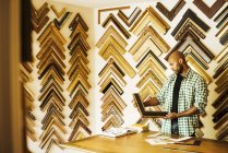 Man working at picture framers — Stock Photo