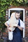 Chef carrying large carcass of animal — Stock Photo