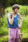 Woman talking on phone in farm — Stock Photo