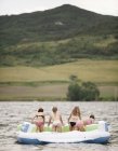 Girls in an inflatable dinghy — Stock Photo
