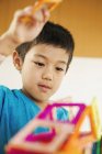 Boy playing with geometric shapes. — Stock Photo