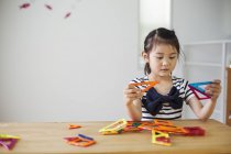 Girl playing with geometric shapes. — Stock Photo