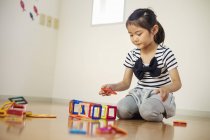 Girl playing with geometric shapes. — Stock Photo