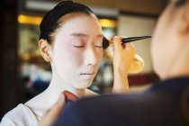 Modern geisha preparing in traditional fashion — Stock Photo