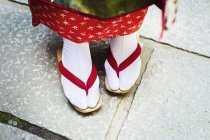 Geisha feet in wooden soled sandals — Stock Photo