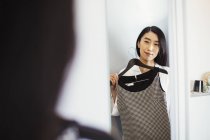 Woman holding a dress on a hanger. — Stock Photo