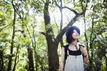 Smiling woman in a forest. — Stock Photo