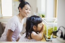 Woman and a child looking at the fish — Stock Photo