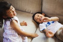 Children playing on the floor, giggling. — Stock Photo