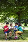 Children sitting round a table — Stock Photo