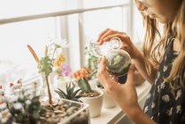 Girl tending plants — Stock Photo
