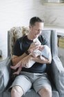 Father cradling small baby — Stock Photo