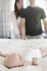Parents standing over young baby — Stock Photo