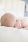 Young baby lying on a bed. — Stock Photo