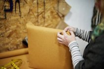 Woman installing yellow fabric — Stock Photo