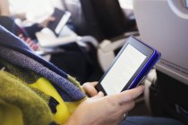 Passenger using digital tablet. — Stock Photo