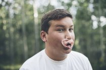 Boy blowing bubble gum bubble — Stock Photo