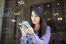 Young Japanese woman using smartphone — Stock Photo