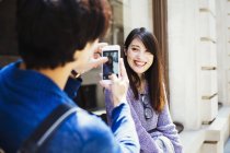 Japanese man taking picture of woman — Stock Photo