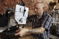 Craftsman at leather workshop — Stock Photo