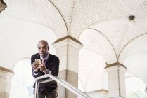 Businessman and checking mobile phone — Stock Photo