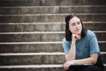 Woman sitting on steps — Stock Photo