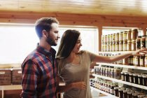 Man and woman in farm shop. — Stock Photo