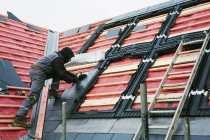 Roofer replacing the tiles — Stock Photo
