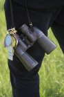 Person carrying pair of binoculars — Stock Photo