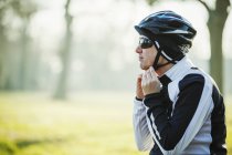 Ciclista che regola il sottogola — Foto stock