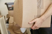 Man carrying cardboard box — Stock Photo