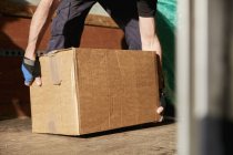 Man lifting cardboard box — Stock Photo