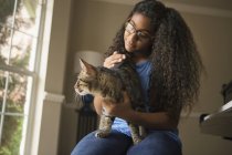 Girl with cat on lap — Stock Photo