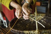 Woman weaving basket — Stock Photo