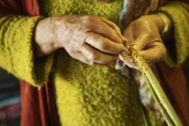 Woman weaving basket — Stock Photo