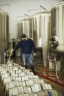 Homem ao lado dos tanques de fermentação — Fotografia de Stock