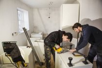 Builders, cutting plasterboard — Stock Photo