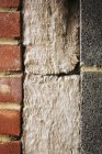 Insulation between a brick and cinder block wall. — Stock Photo