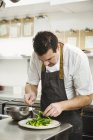 Chef standing in the kitchen — Stock Photo