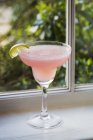 Pink drink in cocktail glass — Stock Photo
