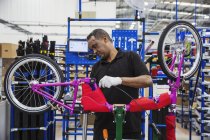 Worker assembling bicycle — Stock Photo