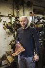 Man standing in shoemaker's workshop — Stock Photo